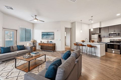 A modern living room with a grey sofa and a wooden coffee table.